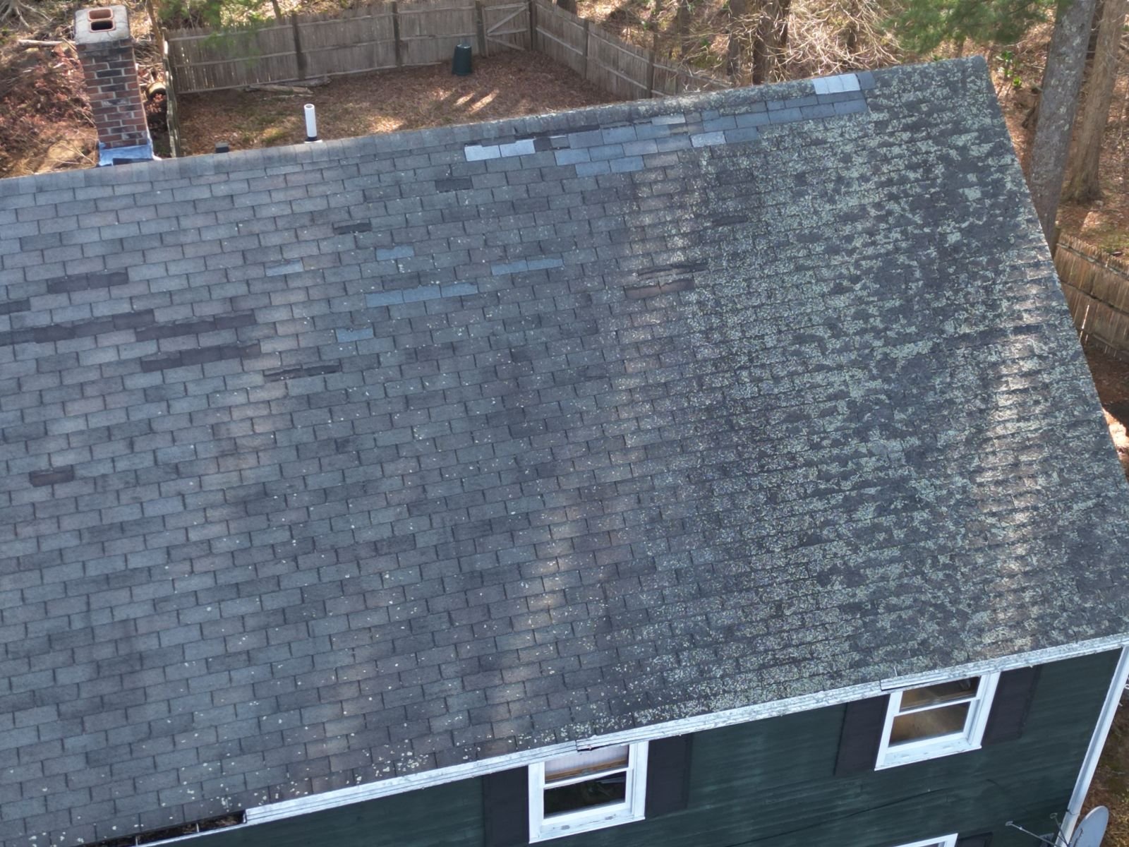 Close drone view of new shingles on a finished roof